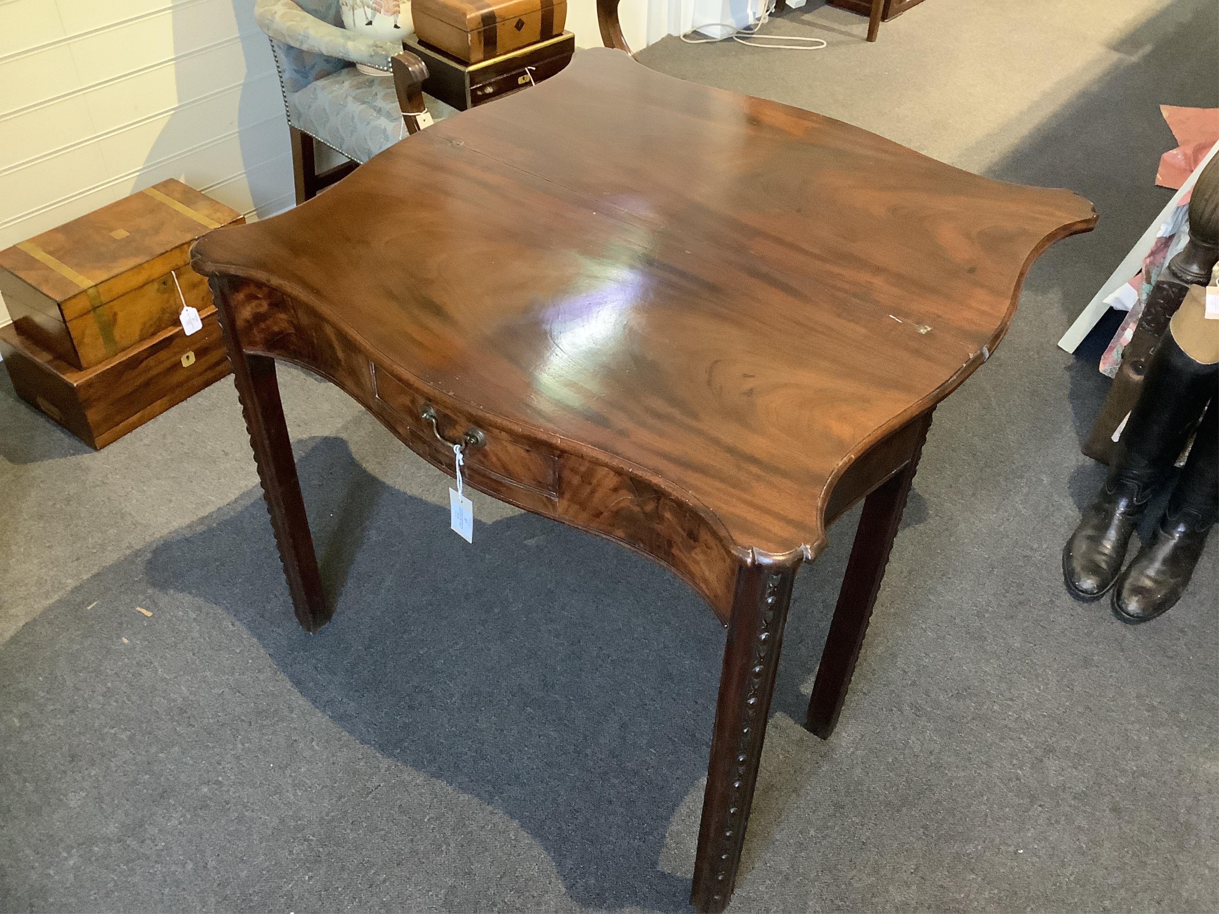 A George III serpentine mahogany tea table